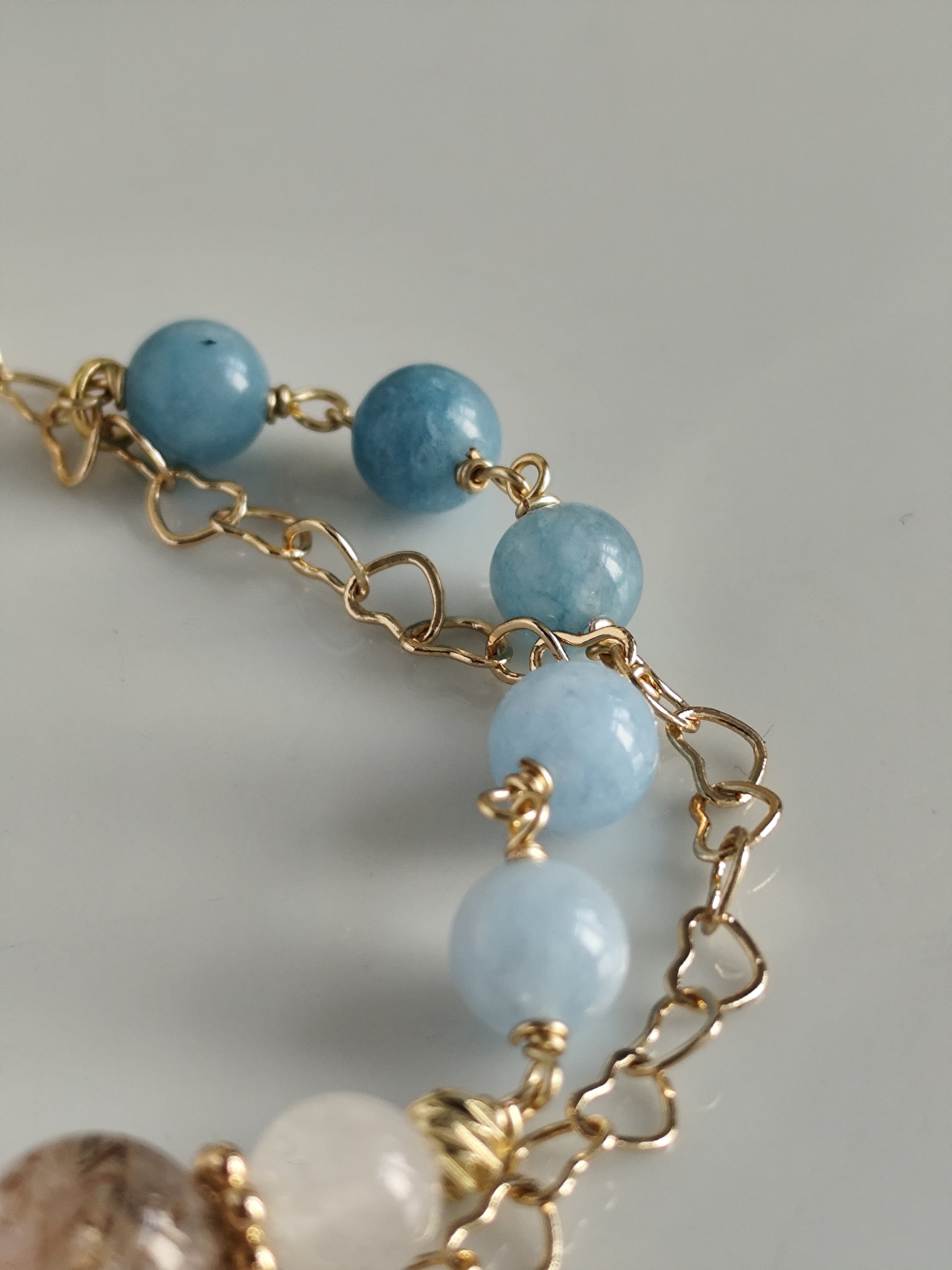 Gemstone bracelet with heart shaped chain