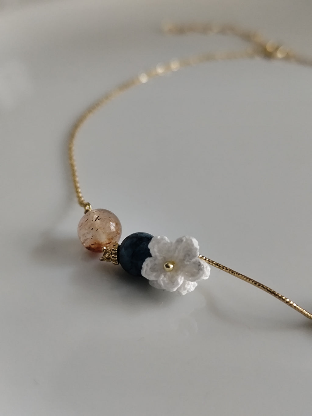 Gemstone design necklace with crocheted flowers