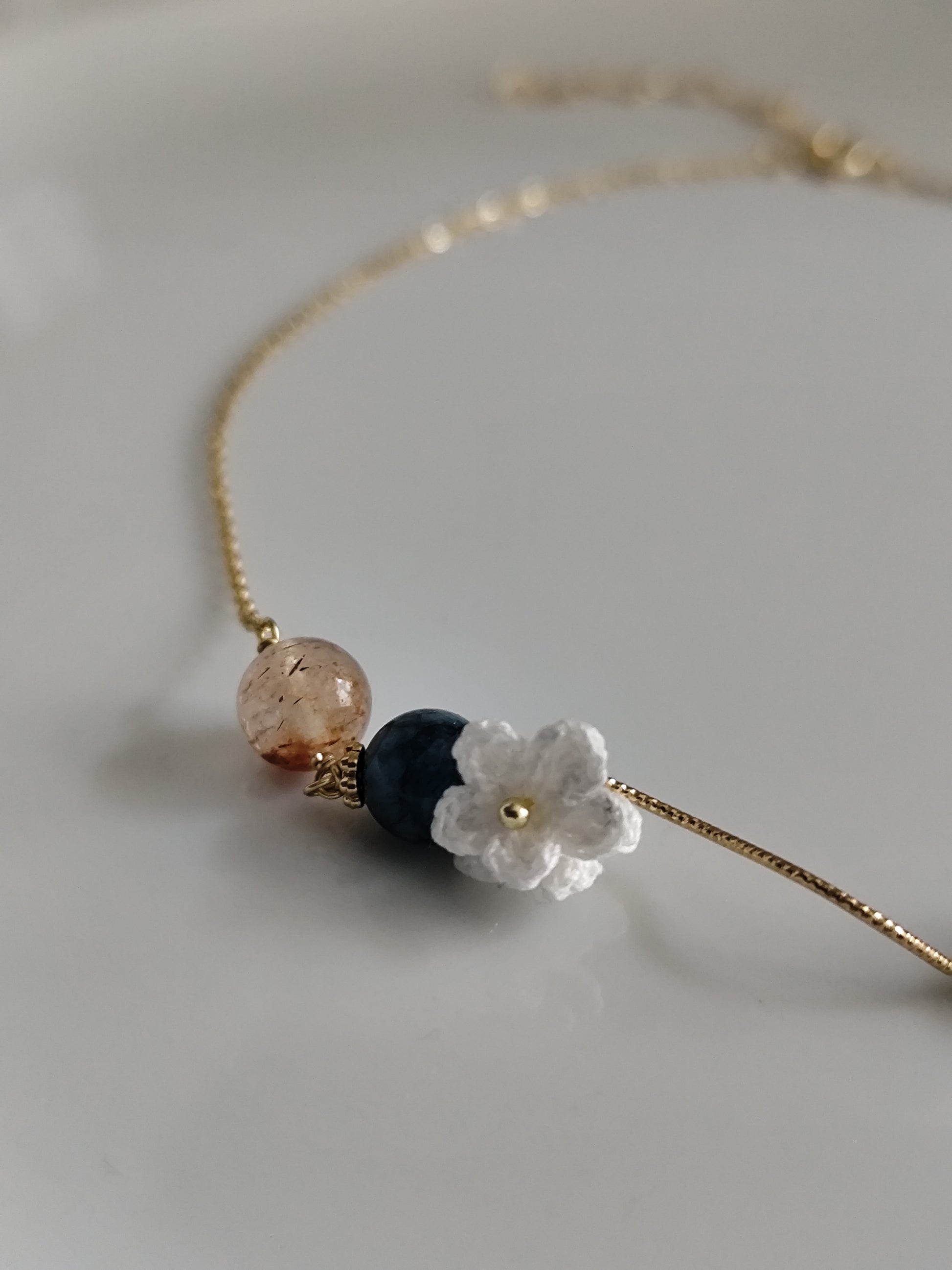 Gemstone design necklace with crocheted flowers